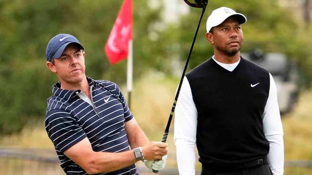 Rory McIlroy and Tiger Woods during the R&A Celebration of Champions four-hole challenge at the 2022 British Open at St. Andrews Old Course.